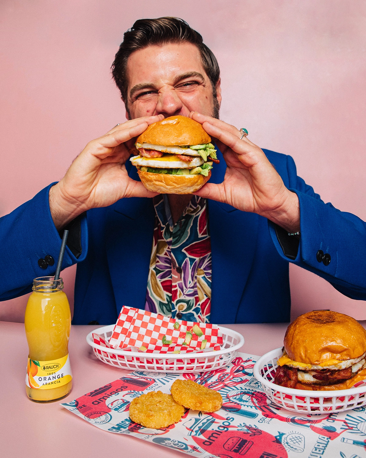 Guy in a suit eating the Amigos Breakfast Burger.